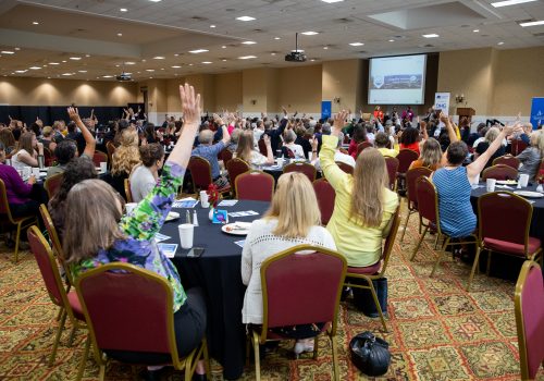 People sitting at tables at a conference